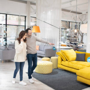 Potential buyers. Two people discussing furniture models in a modern furniture shop